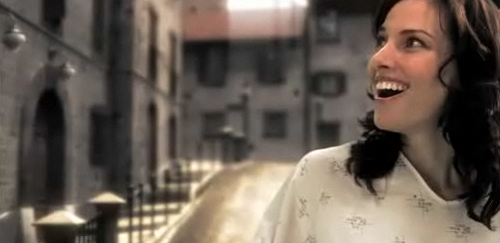 Woman walking down a the streets of a virtual world created by a man that loves her